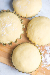 in several tins the cake dough is ready for baking
