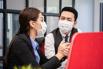 Group of Asian business people wearing face mask, working in office.