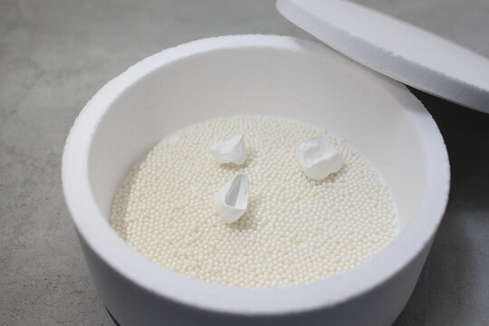 firing the zirconia crown in the oven with high temperature. Dental crown.