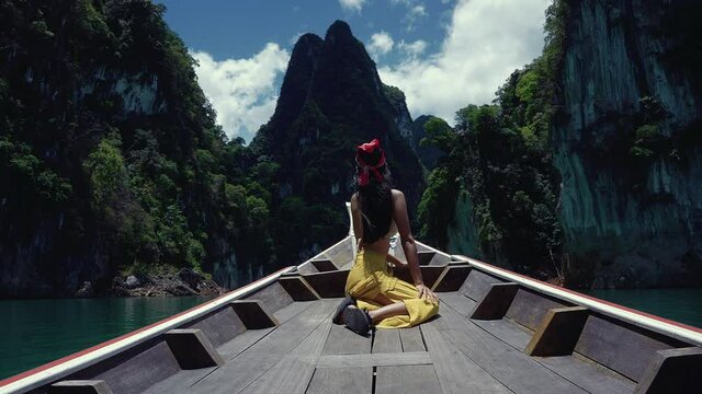 Cute Smiling Asian Sitting on a Long-Tail Boat in Cheow Lan Lake, Thailand.