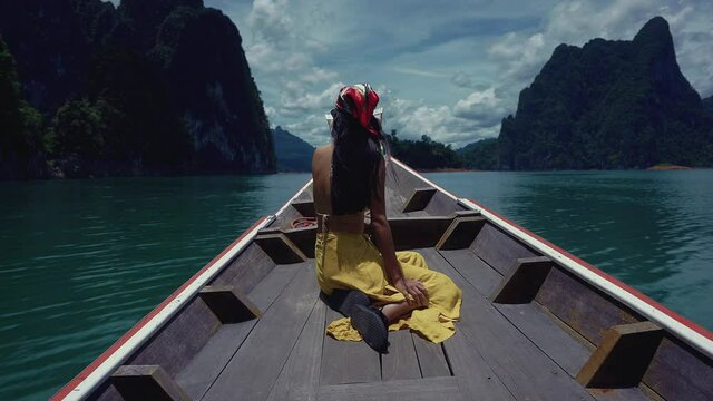 Cute Smiling Asian Sitting on a Long-Tail Boat in Cheow Lan Lake, Thailand.