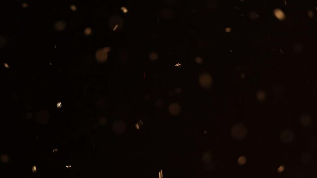 Golden sparkling bokeh glitter with red highlights for film overlay.