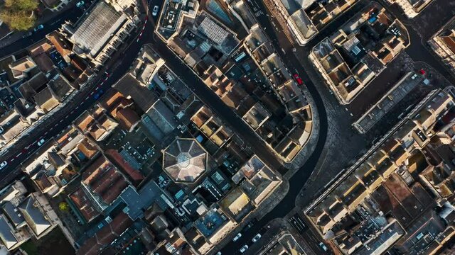 Top down drone shot of old building blocks and streets in Bath city centre UK