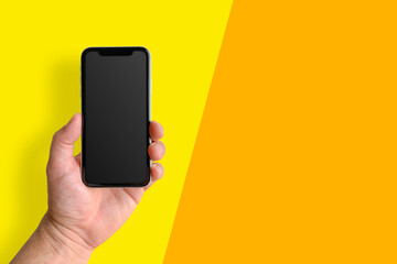 Man holding mobile phone, closeup of hand