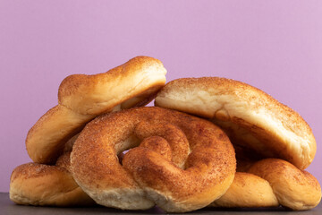Cinnamon sugar pretzels on pink background.