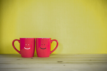 A smiling coffee cup on table.