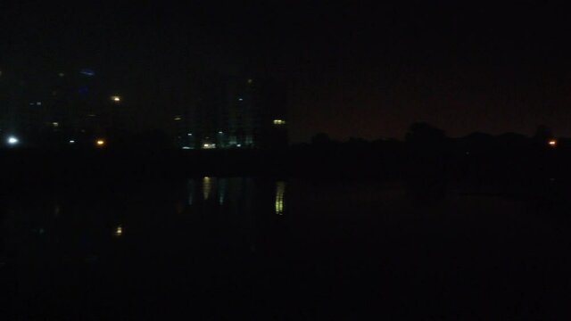 Right To Left Pan Of Forest Apartment Complex At Night Searching For Missing Persons