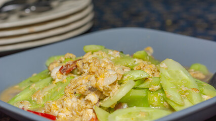 Fried cucumber with egg on natural background.