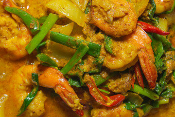 Fried shrimp with curry powder on natural background