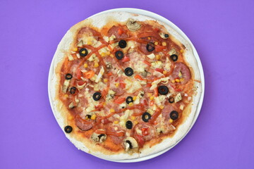 pizza with olives and cheese on  purple background