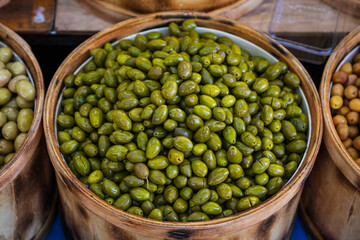 Sales of traditional products.  Mediterranan olives  in the market. Many bowls of olives at the farmer's market