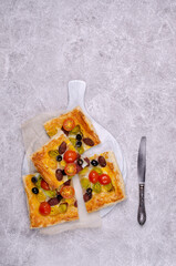 Puff pastry pie with vegetables and sausages