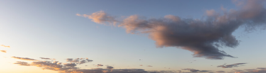 Obraz premium Panoramic View of Cloudscape with puffy sky and clear sunny sunlight during a colorful sunset or sunrise. Taken on the West Coast of British Columbia, Canada.