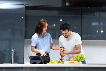Young couple in love. attractive woman and hansome man cooking at kitchen.