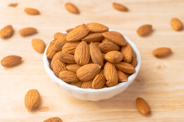 A bowl of roasted almonds, Nuts are low in carbs but high in healthy fats, protein, and fiber. close-up shot.