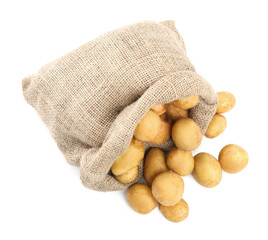 Raw fresh potatoes and sack on white background, top view