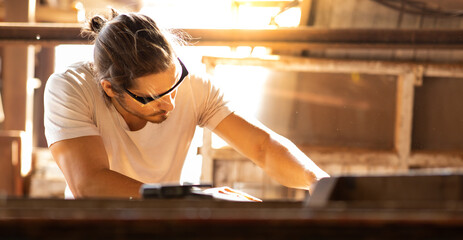 Carpenter woking at wood workshop. Construction industry concept. Tools for woodwrok pencil hammer meter and screw-driver.