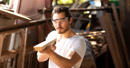 Carpenter woking at wood workshop. Construction industry concept. Tools for woodwrok pencil hammer meter and screw-driver.