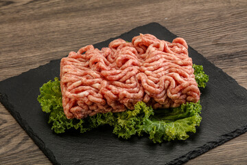 Raw pork minced meat over board