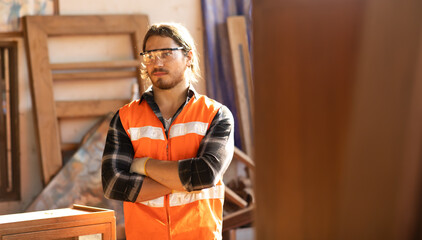 Carpenter woking at wood workshop. Construction industry concept. Tools for woodwrok pencil hammer meter and screw-driver.