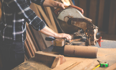 Carpenter work with electrical planer in carpentry workshop. Construction industry concept.