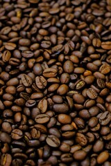 Coffee beans background. Roasted coffee close-up.Texture of coffee beans. space for text.Arabica and Robusta coffee variety.Traditional drink