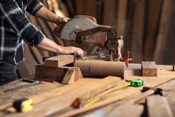 Carpenter work with electrical planer in carpentry workshop. Construction industry concept.