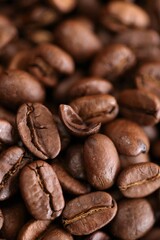 Coffee beans background. Roasted coffee close-up.Texture of coffee beans. space for text.Arabica  coffee variety.Traditional morning drink