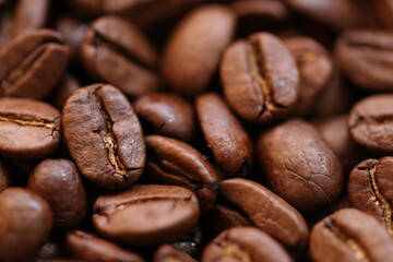 Coffee beans background. Roasted coffee close-up.Texture of coffee beans. space for text. Robusta coffee variety.Traditional morning drink