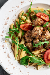 penne pasta with meatballs and tomato sauce, Food recipe background. Close up