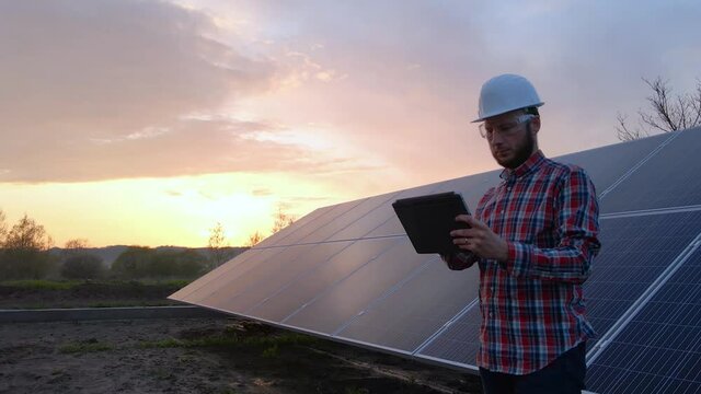 Technical engineer analysing solar farm solar panels data, digital future