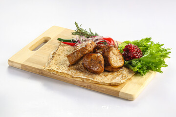 Pork tenderlion kebab over board
