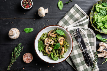 italian pasta penne with grilled mushrooms with spinach. Healthy vegan food. Green vegan pasta. banner, menu recipe place for text, top view