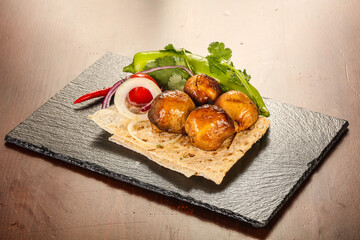 Grilled champignon shashlik over board