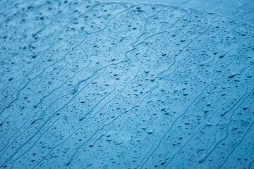 The day was heavy rain, the weather was overcast.Rain water falls on the windshield of car.