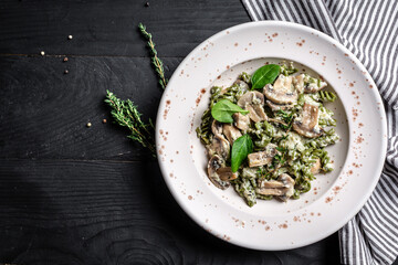 italian pasta penne with grilled mushrooms with spinach. Healthy vegan food. Green vegan pasta. banner, menu recipe place for text, top view