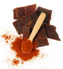 Beef jerky with hot pepper isolated on white background. Dried meat.