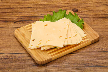 Sliced yellow cheese over board