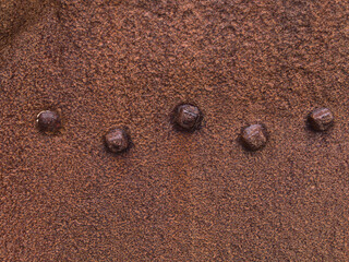 Closeup view of rusty surface with rivets, part of the remains of the wreck of Grimsby fishing trawler Epine (GY7), at Djúpalónssandur beach on the west coast of Snæfellsnes peninsula, Iceland.