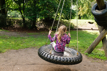 Girl on swing in park.