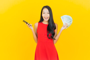 Portrait beautiful young asian woman smile with a lot of cash and money