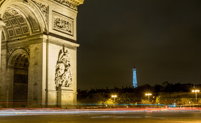 Fototapeta na wymiar Arc de Triomphe with Glistening Eiffel Tower in background
