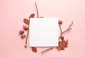 Blank card and autumn leaves on color background