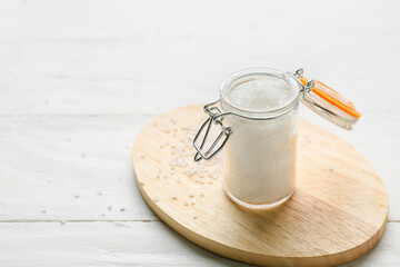 Jar with salt on white wooden background