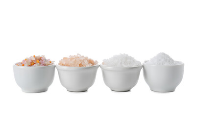 Bowls with different salt on white background
