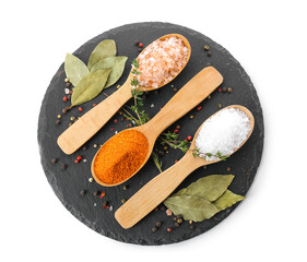 Spoons with different salt and spices on white background