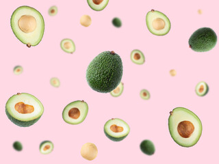 Creative layout with ripe flying avocado halves on pink background.
