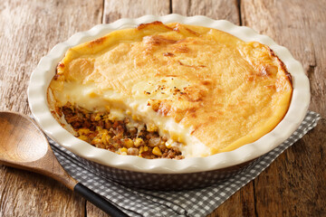 Quebec variety of Shepherd's pie baked close-up in a baking dish on the table. Horizontal