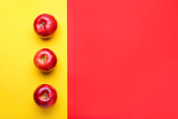 Fresh red apples on color background
