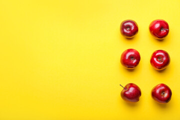 Fresh red apples on color background